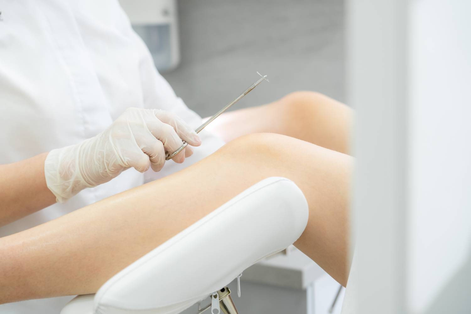 Gynecologist holding needle for stitching before surgery